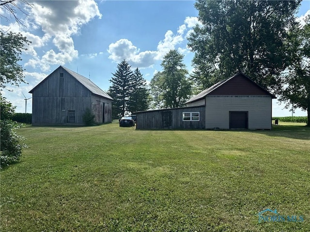 11080 Rd 21, Antwerp, OH 45813 - view of grassy yard featuring a barn, an outbuilding, and a detached garage