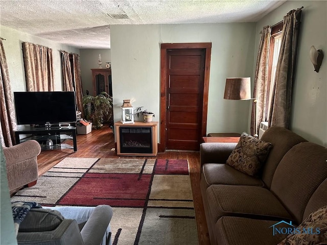 11080 Rd 21, Antwerp, OH 45813 - living room featuring a textured ceiling, wood finished floors, and wine cooler