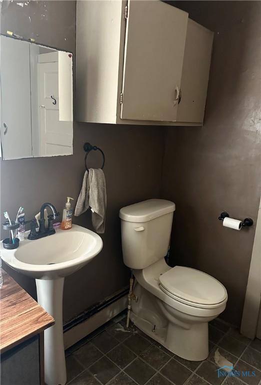 11080 Rd 21, Antwerp, OH 45813 - half bathroom featuring tile patterned floors and a baseboard radiator