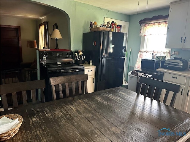 11080 Rd 21, Antwerp, OH 45813 - kitchen featuring black appliances, arched walkways, white cabinets, and light countertops