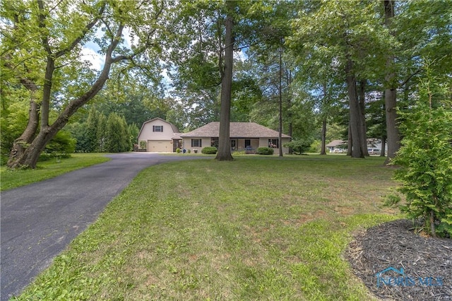 8411 Larch Rd, Toledo, OH 43617 - view of front of property featuring a front lawn, asphalt driveway, and a garage