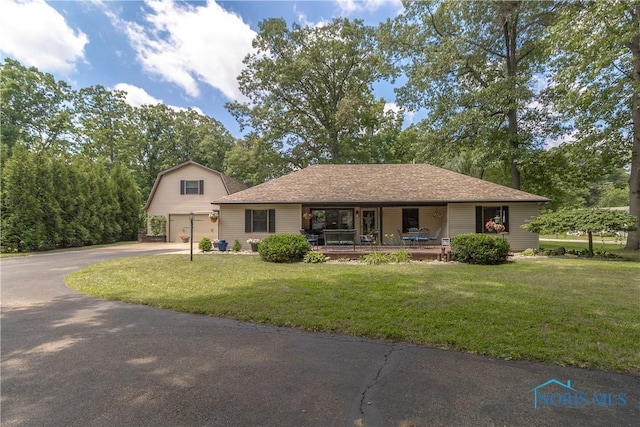 8411 Larch Rd, Toledo, OH 43617 - view of front of property with driveway, a front lawn, and a porch