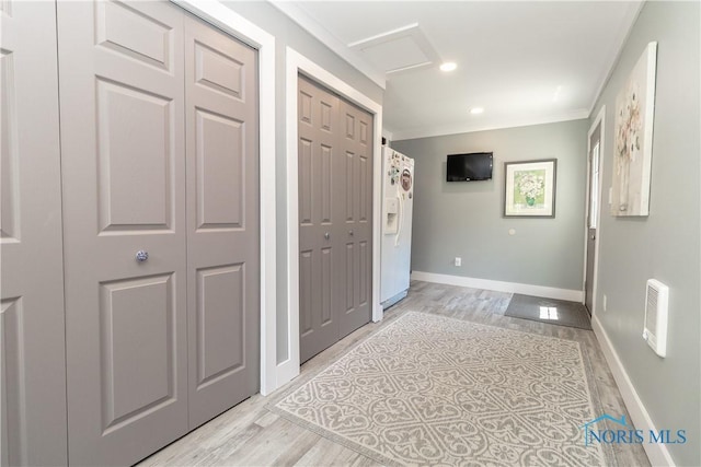 8411 Larch Rd, Toledo, OH 43617 - hall with light wood-style floors, ornamental molding, attic access, recessed lighting, and heating unit