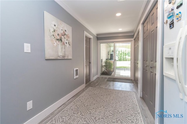 8411 Larch Rd, Toledo, OH 43617 - doorway to outside featuring ornamental molding, light wood-type flooring, recessed lighting, and heating unit