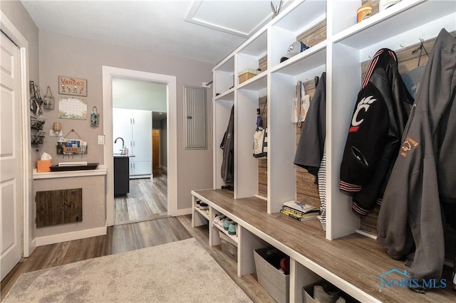 8411 Larch Rd, Toledo, OH 43617 - mudroom with wood finished floors, electric panel, and attic access