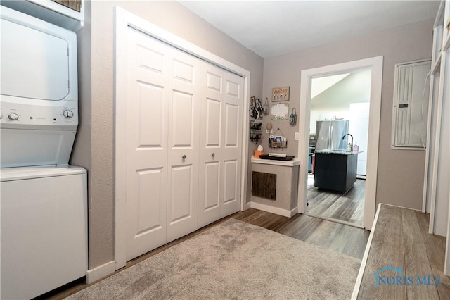 8411 Larch Rd, Toledo, OH 43617 - laundry area with stacked washer / dryer and wood finished floors