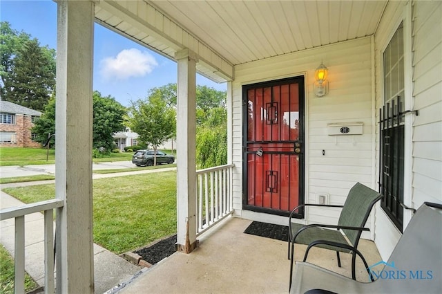 1939 Macomber St, Toledo, OH 43606 - doorway to property featuring a porch and a lawn