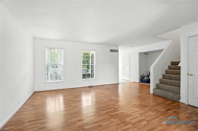 1939 Macomber St, Toledo, OH 43606 - unfurnished living room with wood finished floors and stairs