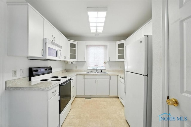 1939 Macomber St, Toledo, OH 43606 - kitchen with white appliances, glass insert cabinets, light countertops, and white cabinetry