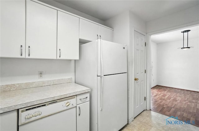 1939 Macomber St, Toledo, OH 43606 - kitchen featuring white appliances, light countertops, white cabinetry, and decorative light fixtures
