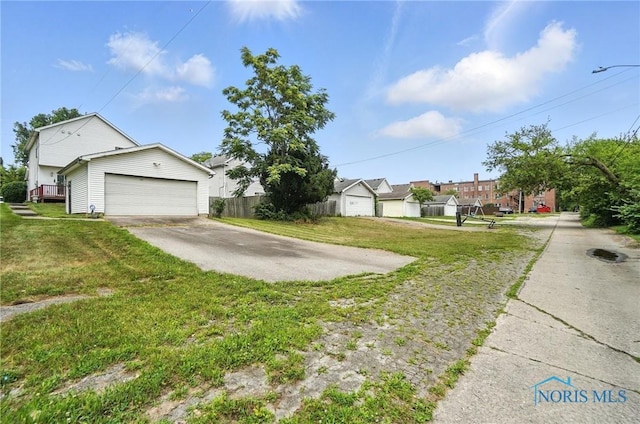 1939 Macomber St, Toledo, OH 43606 - view of yard featuring a garage and concrete driveway