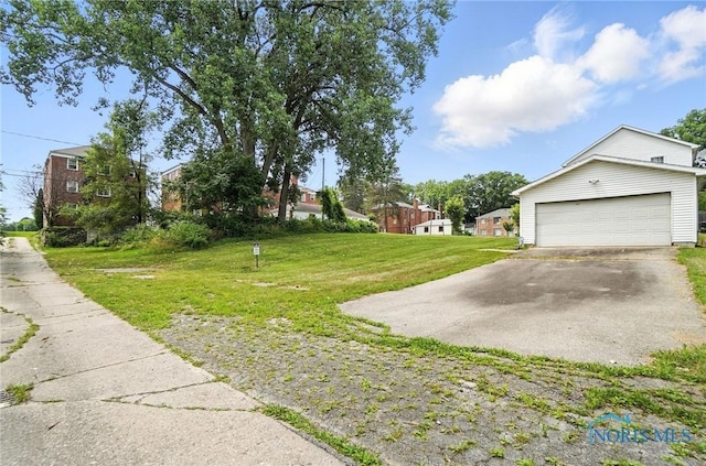 1939 Macomber St, Toledo, OH 43606 - view of green lawn with driveway and an attached garage