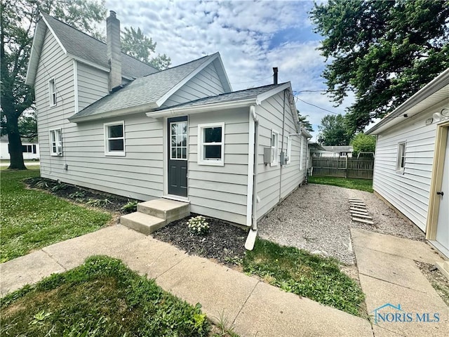 339 N E Ave, Deshler, OH 43516 - view of front facade with a shingled roof and a chimney