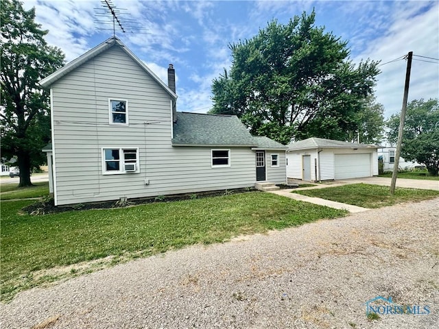 339 N E Ave, Deshler, OH 43516 - view of front of property featuring entry steps, an outbuilding, a chimney, a shingled roof, and a front yard
