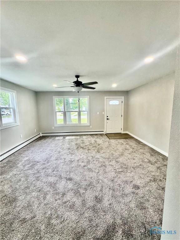 339 N E Ave, Deshler, OH 43516 - unfurnished living room with carpet flooring, plenty of natural light, and a ceiling fan