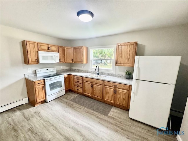 339 N E Ave, Deshler, OH 43516 - kitchen featuring white appliances, baseboard heating, light wood-style floors, light countertops, and brown cabinetry