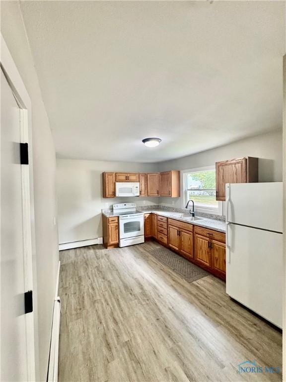 339 N E Ave, Deshler, OH 43516 - kitchen featuring white appliances, baseboard heating, and light wood-type flooring