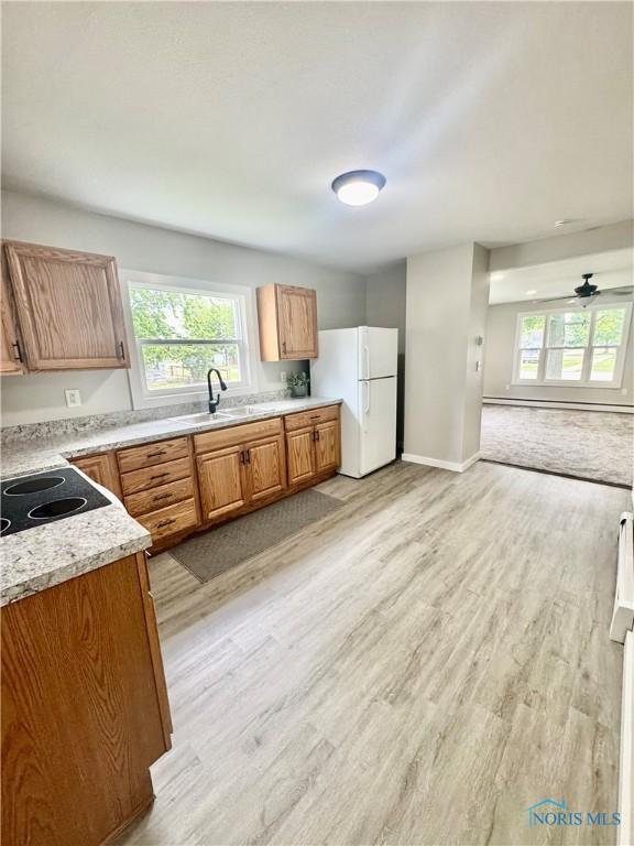 339 N E Ave, Deshler, OH 43516 - kitchen featuring freestanding refrigerator, light wood finished floors, and healthy amount of natural light