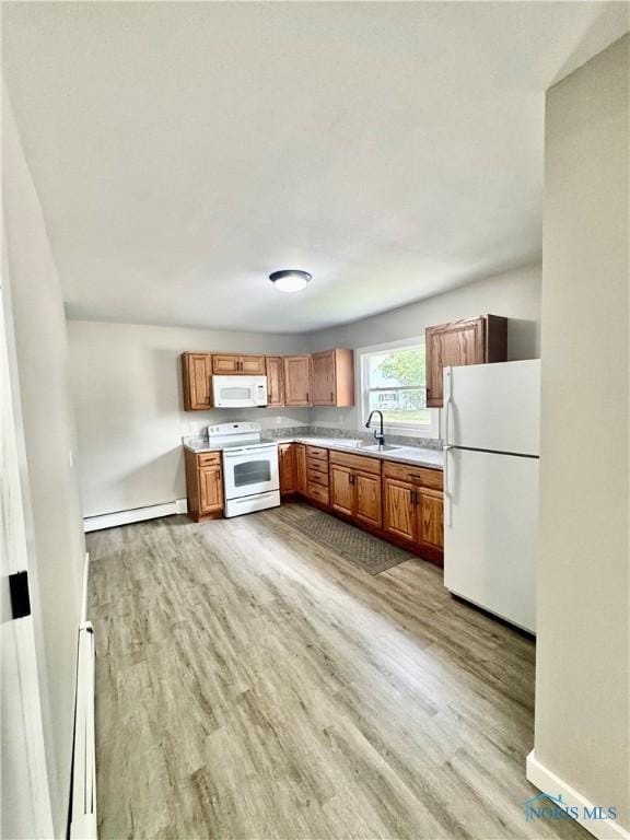 339 N E Ave, Deshler, OH 43516 - kitchen featuring white appliances, baseboard heating, a baseboard radiator, light wood-style flooring, and light countertops