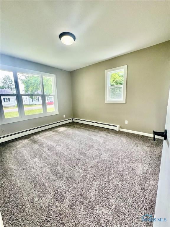 339 N E Ave, Deshler, OH 43516 - carpeted empty room with healthy amount of natural light and a baseboard heating unit
