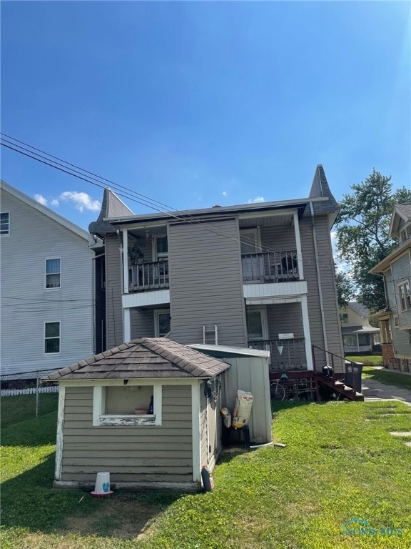421 Oswald St, Toledo, OH 43605 - back of property with a lawn and a balcony
