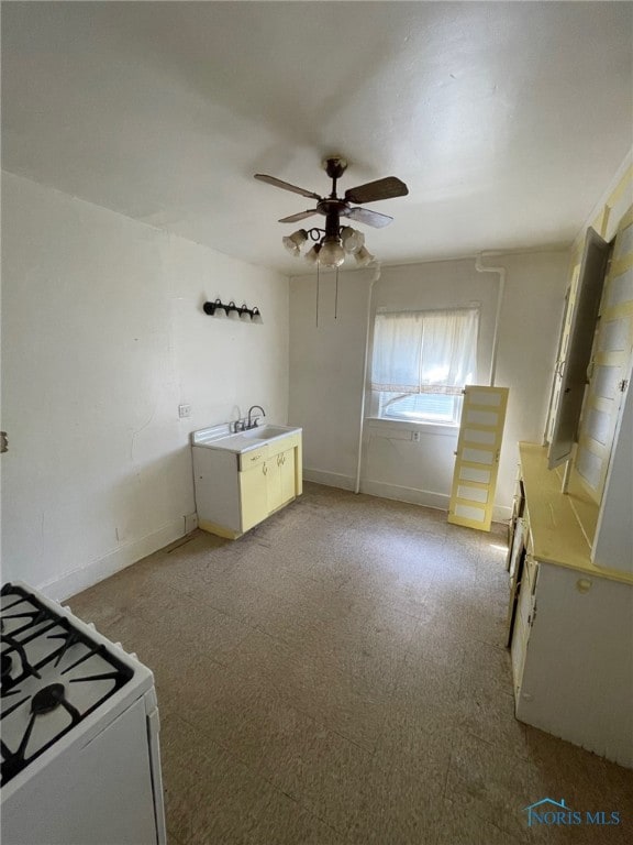 421 Oswald St, Toledo, OH 43605 - kitchen featuring ceiling fan, gas range gas stove, light colored carpet, and light countertops