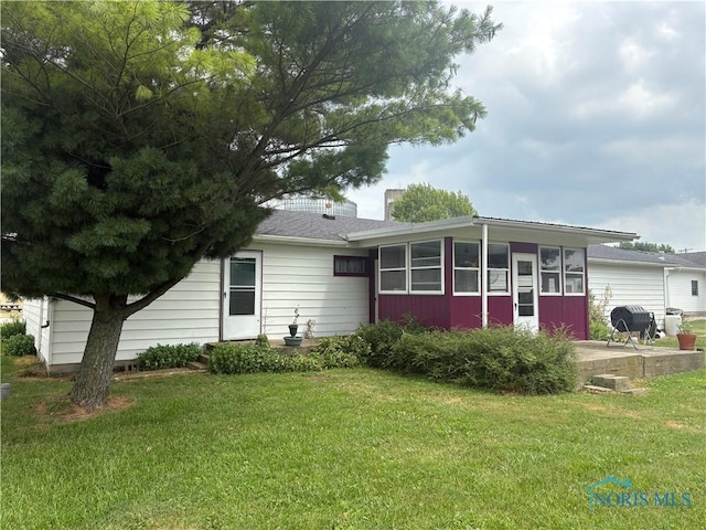 9097 Custar Rd, Custar, OH 43511 - view of front facade featuring a front yard and a sunroom