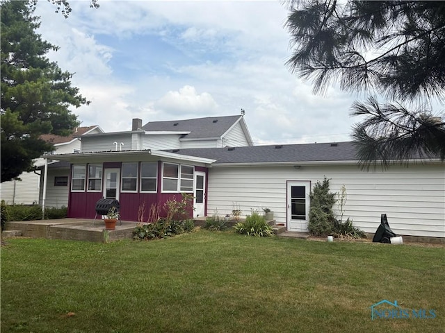 9097 Custar Rd, Custar, OH 43511 - rear view of house with a sunroom, a yard, and a patio