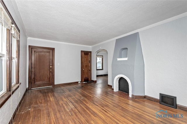2517 Montebello Rd, Toledo, OH 43607 - unfurnished living room featuring dark wood-style flooring, arched walkways, a textured ceiling, and ornamental molding