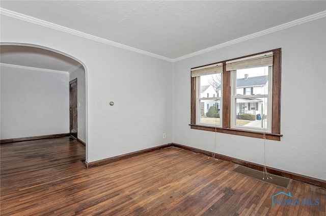 2517 Montebello Rd, Toledo, OH 43607 - empty room featuring arched walkways, wood finished floors, and ornamental molding