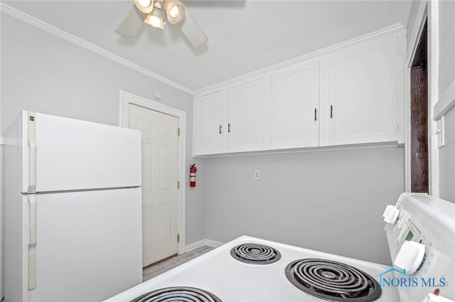 2517 Montebello Rd, Toledo, OH 43607 - kitchen with freestanding refrigerator, a ceiling fan, white cabinetry, ornamental molding, and stove