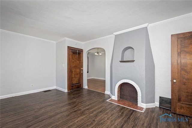 2517 Montebello Rd, Toledo, OH 43607 - unfurnished living room with wood finished floors, arched walkways, a brick fireplace, crown molding, and a chandelier