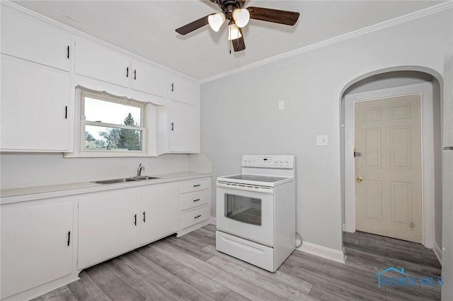 2517 Montebello Rd, Toledo, OH 43607 - kitchen with white electric range, crown molding, a ceiling fan, white cabinets, and light wood-type flooring