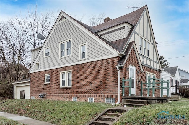 2517 Montebello Rd, Toledo, OH 43607 - view of home's exterior featuring brick siding, a lawn, and a chimney