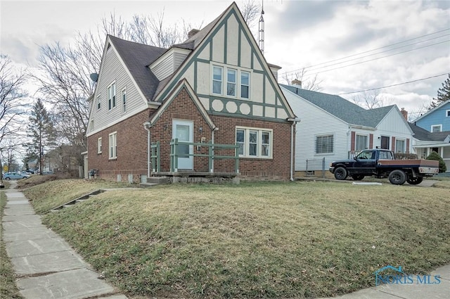 2517 Montebello Rd, Toledo, OH 43607 - tudor-style house with brick siding, a front lawn, and stucco siding