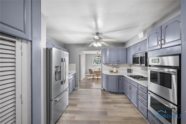 5201 Arbor Way, Sylvania, OH 43560 - kitchen featuring appliances with stainless steel finishes, gray cabinetry, ceiling fan, light countertops, and light wood-style floors
