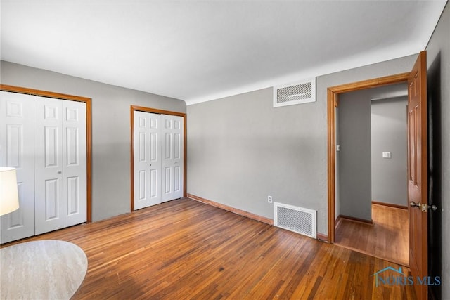 5201 Arbor Way, Sylvania, OH 43560 - unfurnished bedroom with multiple closets and wood finished floors