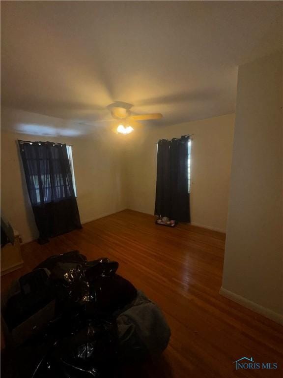 1421 N Ravine Pkwy, Toledo, OH 43605 - unfurnished living room with wood finished floors and a ceiling fan