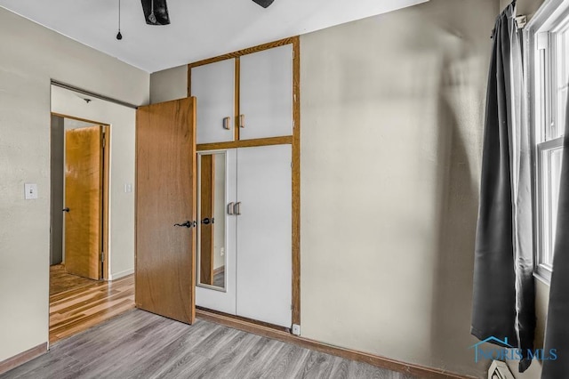 3253 Radford Dr, Toledo, OH 43614 - unfurnished bedroom featuring wood finished floors, a closet, and baseboard heating
