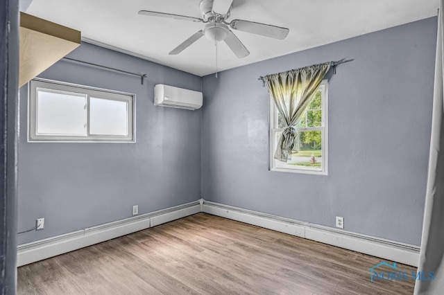 3253 Radford Dr, Toledo, OH 43614 - spare room with a wall mounted AC, wood finished floors, a ceiling fan, and baseboard heating