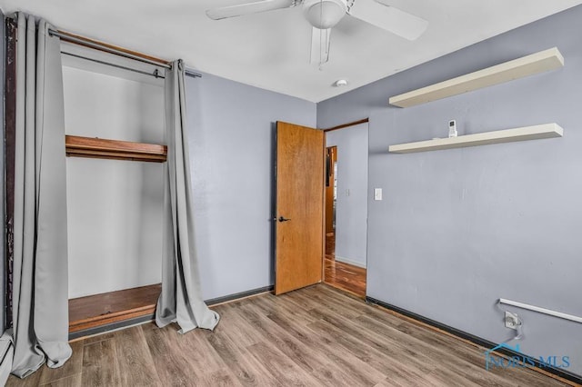 3253 Radford Dr, Toledo, OH 43614 - unfurnished bedroom with a closet, wood finished floors, a ceiling fan, and a baseboard radiator
