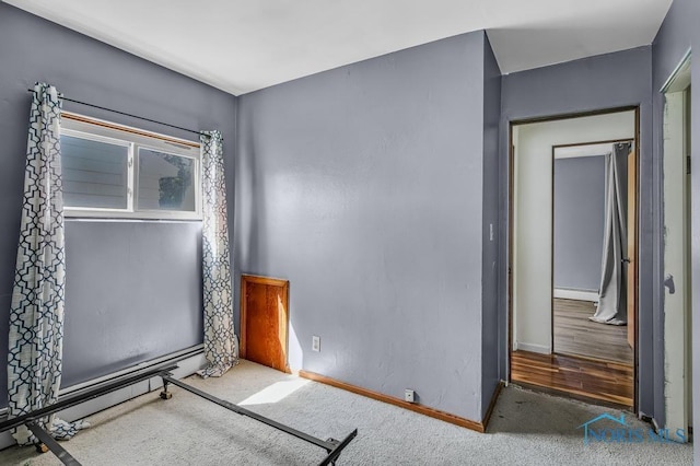 3253 Radford Dr, Toledo, OH 43614 - unfurnished bedroom with a baseboard heating unit and carpet floors