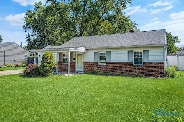 3253 Radford Dr, Toledo, OH 43614 - view of front of home with brick siding, a chimney, and roof with shingles
