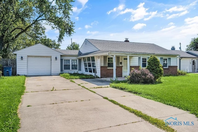 3253 Radford Dr, Toledo, OH 43614 - view of front of property featuring brick siding, an attached garage, driveway, and a porch