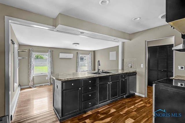 3253 Radford Dr, Toledo, OH 43614 - kitchen featuring dishwasher, a peninsula, range, dark wood-style flooring, and dark cabinetry