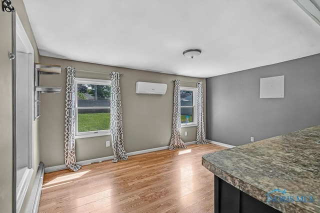 3253 Radford Dr, Toledo, OH 43614 - dining space featuring a wall unit AC and wood finished floors