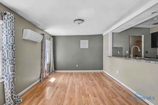 3253 Radford Dr, Toledo, OH 43614 - spare room with a wall mounted AC and light wood-style flooring