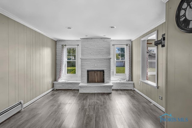 3253 Radford Dr, Toledo, OH 43614 - unfurnished living room with a baseboard radiator, ornamental molding, wood finished floors, and a stone fireplace
