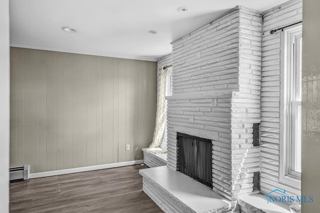 3253 Radford Dr, Toledo, OH 43614 - unfurnished living room featuring baseboard heating, a large fireplace, wood finished floors, and crown molding