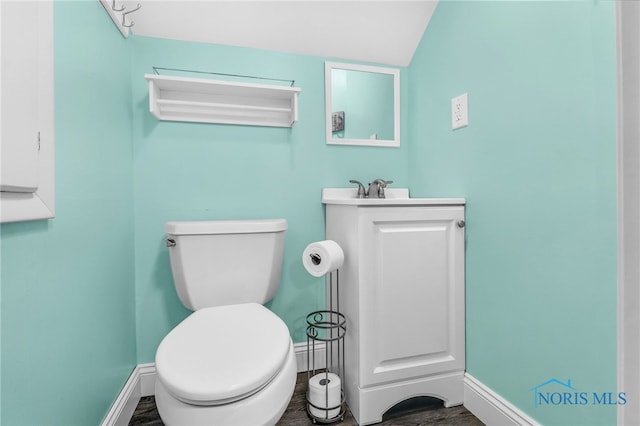 3122 Winston Blvd, Toledo, OH 43614 - half bathroom with wood finished floors, vanity, and vaulted ceiling